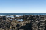 The rocky coastline on which the house sits.